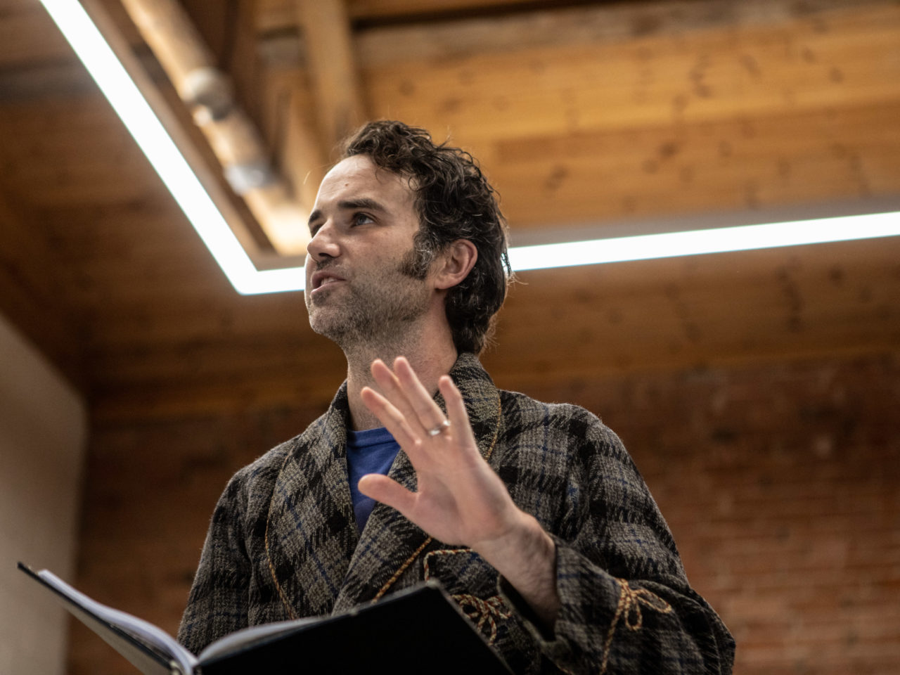 Nick rehearsing his lines in the rehearsal room. He is wearing a smart robe.